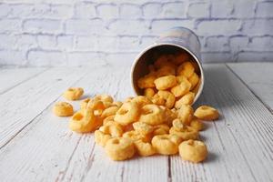 Tasty potato chips spilling from a container photo