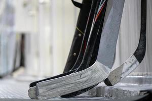 Hockey sticks near the locker room before the game photo