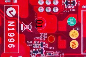 Electronic Printed Circuit Board in red with Electronic components- top view