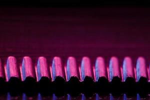 Edge of an illuminated  serrated knife photo