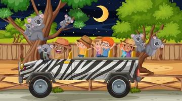 Safari at night scene with many kids watching koala group vector