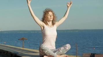 Young woman practicing yoga outdoors in summer Healthy lifestyle