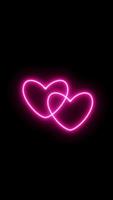 dois corações batendo em uníssono. vídeos animados de sinal de amor de néon rosa. looping animação realista. vídeo vertical video