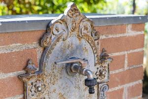 faucet of a vintage garden fountain photo