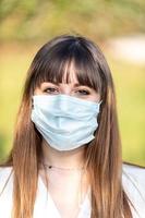 girl wearing medical mask cause covid 19 photo