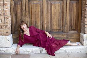 girl lying on the ground on a landing of a door photo