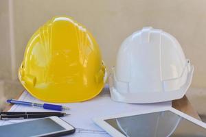 Yellow hard hat safety for engineering on desk in office photo