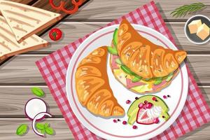 Sándwich de croissant de desayuno con verduras y huevo en la mesa vector