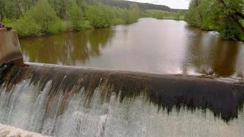Dam on the river. Waterfall, Strong current, Aerial filming video