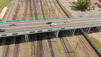 Aerial shot of a road bridge passing over a railroad track video