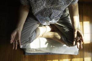 Senior mujer budista asiática practicando meditación foto