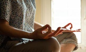 Senior Asian Buddhist woman practicing meditation photo