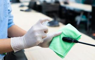 Spraying disinfectant on cloth photo