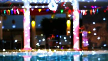 Reflection Blurred and bokeh dancing blue lights of party at luxury pool side video