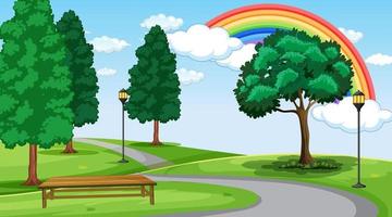 Escena del paisaje del parque con arco iris en el cielo vector