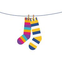 socks pair with colors stripes hanging in wire vector