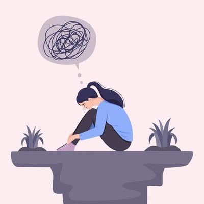 Young woman in depression hugging her knees and crying