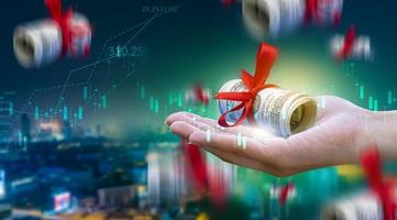 Business people hold a tablet, plan and strategy and display virtual holograms of statistics, financial graphs, securities and charts on a dark background. The concept of business growth photo