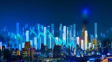 Business people hold a tablet, plan and strategy and display virtual holograms of statistics, financial graphs, securities and charts on a dark background. The concept of business growth photo