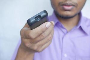 close up of man hand holding tv remote. photo