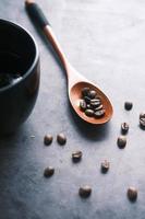 top view of fresh coffee beans on black background with copy space. photo