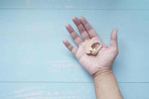 Hearing aid machine on palm of hand photo