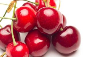 Small red cherries on a white background photo