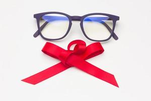 Black plastic glasses with a red bow photo