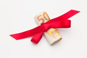 Gift money wrapped with a ribbon and a bow photo