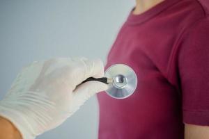 Doctor using stethoscope to check heart rate, heart disease , World heart day photo