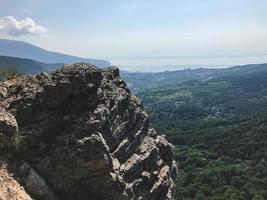 High cliff under the forest of Crimea photo