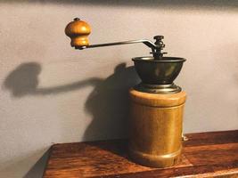 Manual coffee grinder standing on the shelf photo