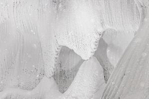 White embossed walls of ice and snow in a cave photo