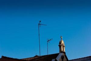 Silhouette of the roof and cross of a church photo