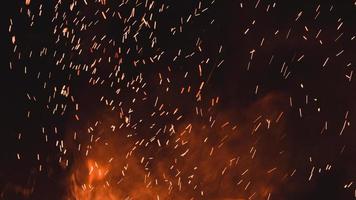 Close up of sparks from fire, sparks on black background, extravaganza of fire, magic with sparks. photo