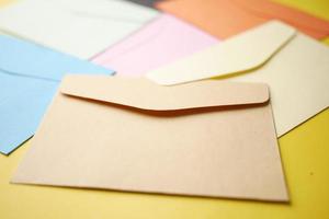 Colorful envelope on yellow background with copy space photo
