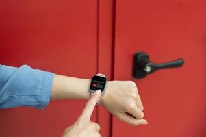 Close up hand wearing smartwatch Photo