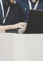 Business man on conference holding and drinking watter bottle. photo