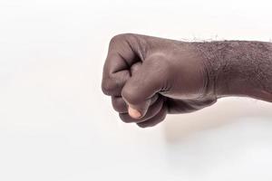 Male hand clenched into a fist on a white background photo