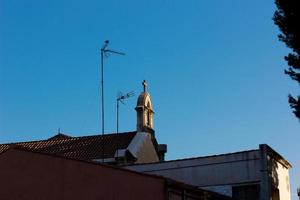 Silhouette of the roof and cross of a church photo