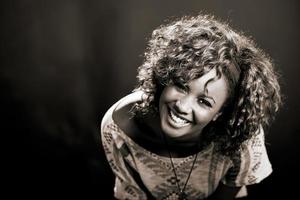Beautiful black woman on black background. Studio shot photo