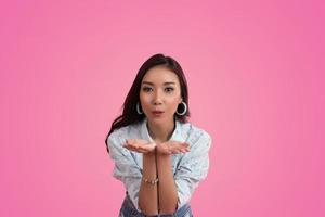 Happy Asian woman on pink background photo