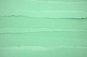 Vintage neutral torn green papers abstract texture background. photo