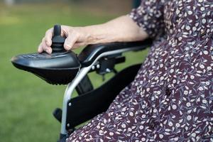 Asian senior or elderly old lady woman patient on electric wheelchair with remote control at nursing hospital ward, healthy strong medical concept photo