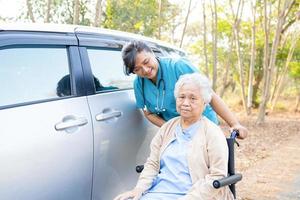 Doctor help and care Asian senior or elderly old lady woman patient sitting on wheelchair at nursing hospital ward healthy strong medical concept photo