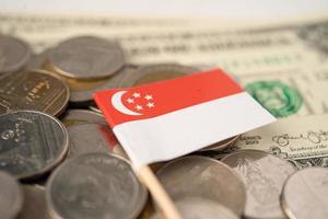 Pila de monedas con la bandera de Singapur sobre fondo blanco. foto