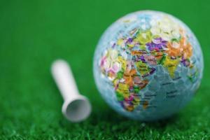Bangkok, Thailand, July 1, 2020 World globe map at golf ball with on green lawn or field.