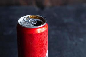Red drink can and  Black sparkling water photo