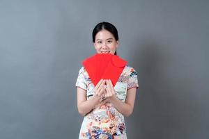 Asian woman wear Chinese traditional dress with red envelope or red packet photo