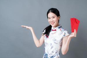 Asian woman wear Chinese traditional dress with red envelope or red packet photo